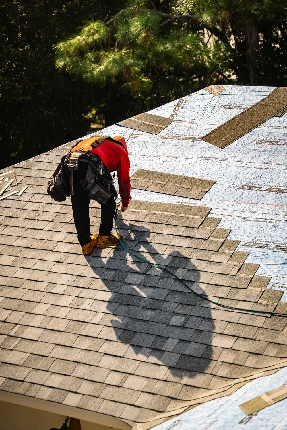 Roofer placing roofing material with precision