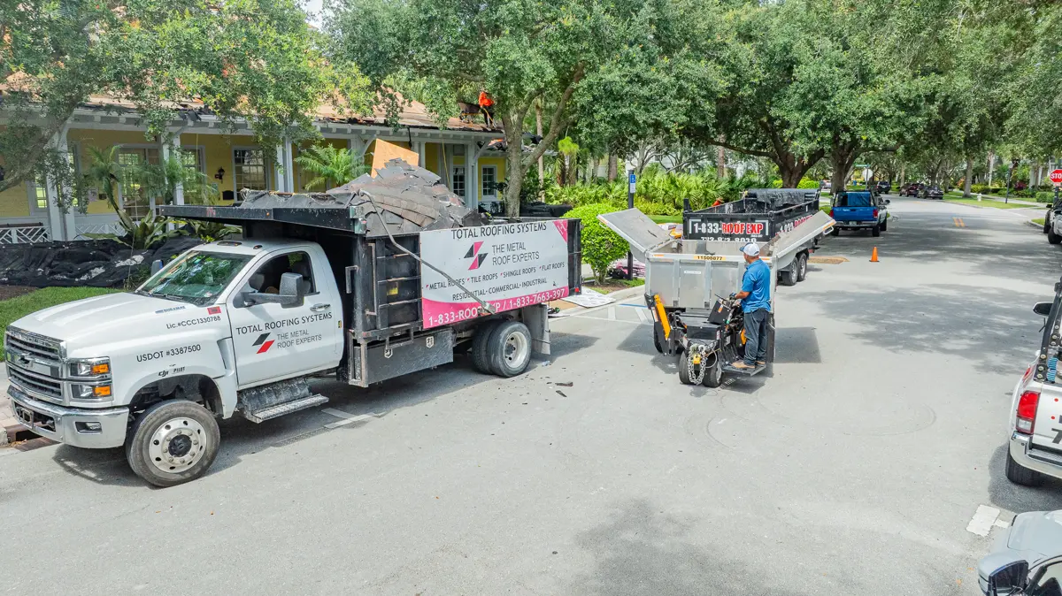 Total Roofing Systems branded trucks and crew on a South Florida jobsite